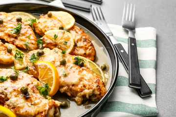 Delicious chicken piccata with sauce and lemon on plate