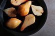 Pears with wine and spices in dish, closeup