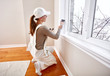 © grinny - Woman painting window trim