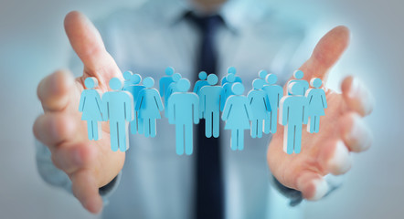 Aufkleber - Businessman holding 3D rendering group of people in his hand