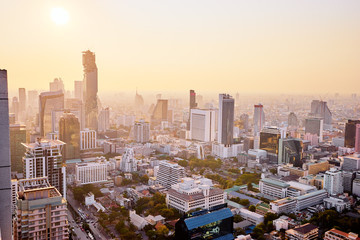 Wall Mural - Sunset in megapolis. Beautiful cityscape with top view on skyscrapers. Bangkok, Thailand.