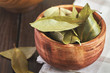 Dry bay leaves (Laurus nobilis) in wooden bowl