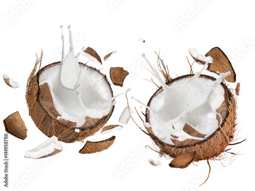 Stampe close-up of a coconuts with milk splash.