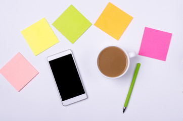 White background, smartphone and cup of hot coffee.