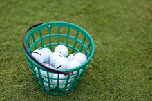 Golf Balls In The Basket On A Grass Background