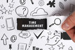 © Egor - Business, Technology, Internet and network concept. Young businessman shows the word: Time management