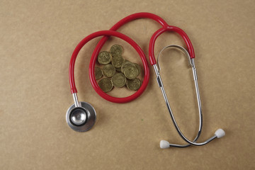 Wall Mural - Red stethescope on wooden background. Medical and health care concept.