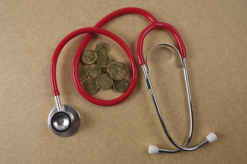 Wall Mural - Red stethescope on wooden background. Medical and health care concept.