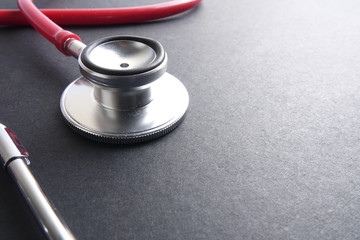 Wall Mural - Red stethoscope,keyboard ,puzzle and coins. Medical concept.