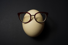 Ostrich Egg With Glasses In Pan On Black Background