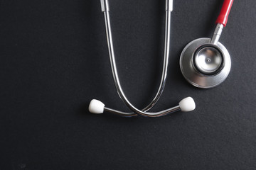 Wall Mural - Red stethoscope,keyboard ,puzzle and coins. Medical concept.