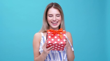 Canvas Print - Young smiling woman glad about gift isolated