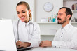 © JackF - Male visitor consulting smiling woman doctor in hospital