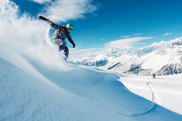 snowboarder is riding from mountain