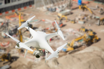 Unmanned Aircraft System (UAV) Quadcopter Drone In The Air Over Construction Site.