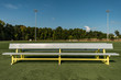 © clsdesign - Empty aluminum bench team sports background on a green turf field