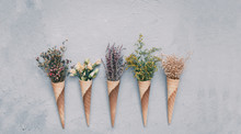 Creative Still Life Of An Ice Cream Waffle Cone With Dried Flowers On Grey Background