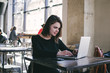 © sashafolly - Young woman sittingand using a laptop