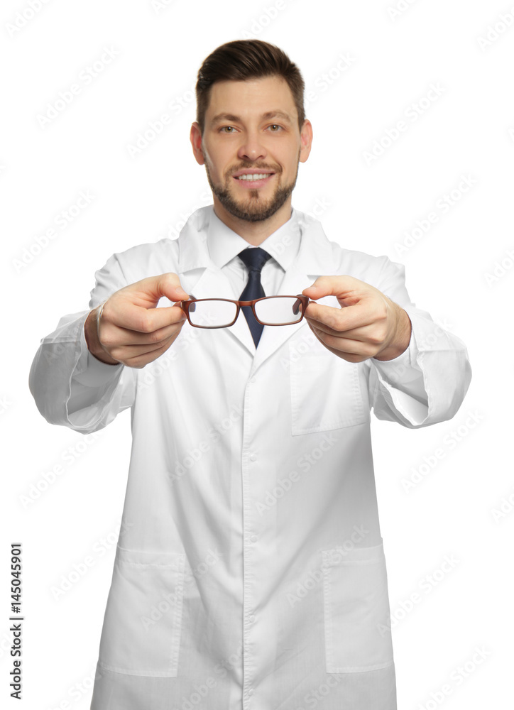 Handsome ophthalmologist holding glasses on white background