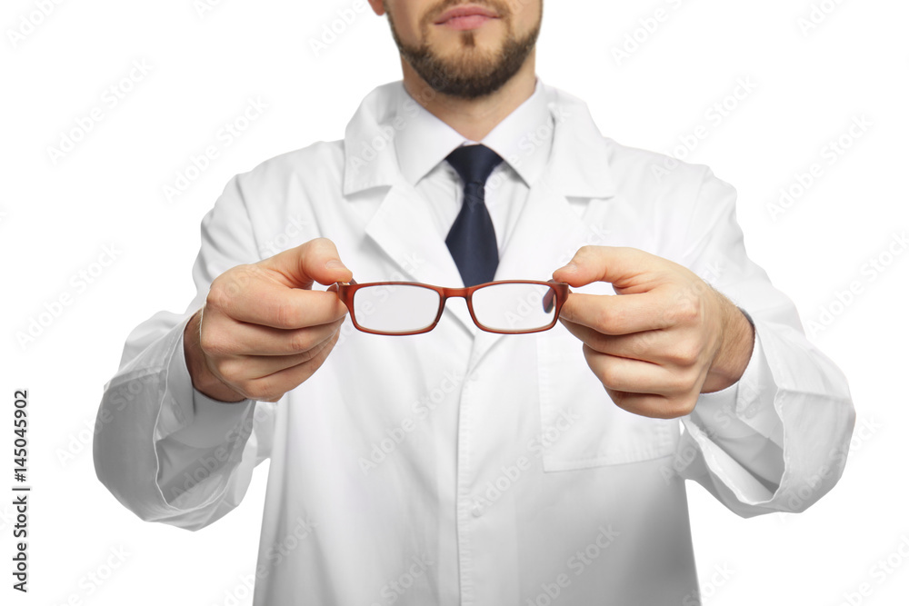 Handsome ophthalmologist holding glasses on white background