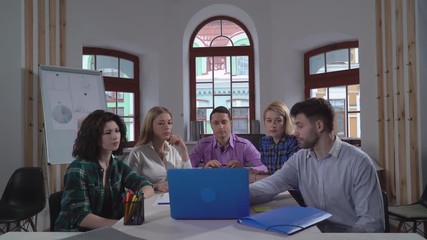 Aufkleber - Meeting in the office. Young creative professional team sharing new ideas and discussing strategy. People looking on screen laptop and pointing some changes in project.