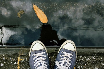 Sneakers, explore the world concept, Sport sneakers from an aerial view on concrete pavement. Top view.