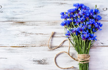 Blue Flowers, Summer Wildflowers Bouquet On White Wooden Backgro