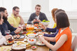 © Prostock-studio - Group of happy young people at dinner table, friends party