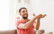 happy man holding something imaginary at home