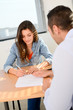 © W PRODUCTION - beautiful young woman in office with professional finance businessman buying agreement contract signature