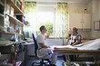 © Astrakan Images - Doctor talking to patient in office at hospital