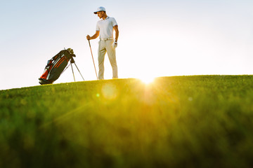 Wall Mural - Male golfer standing on golf course