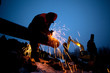 © stetsko - A worker grinds a pipe on the construction of a pipeline