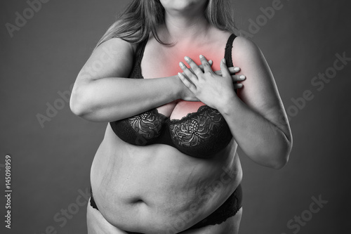 Fotografie, Tablou Fat woman with heart attack, pain in chest, overweight female body on gray backg