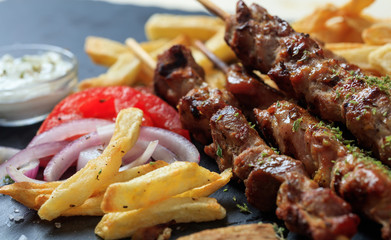 Grilled meat skewers and side dish