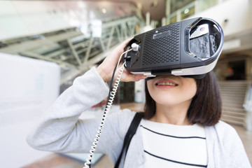 Wall Mural - Woman watching though VR device