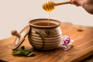 Wall Mural - Honey Pot with Dripping Liquid Honey