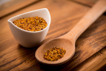 Wall Mural - Bee Pollen in a bowl on a wooden surface