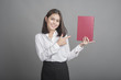 © tonefotografia - Beautiful teacher Woman holding book on grey background