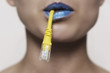 © grufnar - close-up of a female face with heavy blue lipstick holding a network cable in her mouth