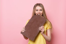 Woman With Chocolate Smiling. Cute Girl Holding And Eating Giant Cocoa Chocolate Bar Near Pink Wall.