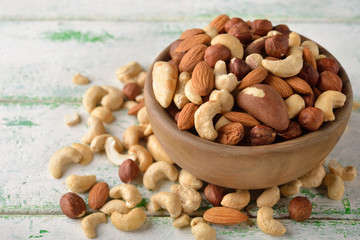 Canvas Print - Mix of different nuts in a wooden bowl