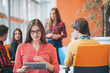 © FS-Stock - happy young business woman with her staff, people group in background at modern bright office indoors
