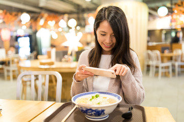 Poster - Woman taking photo in her ramen in restaurant