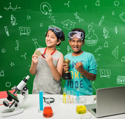 2 little indian kids doing science experiment or chemistry experiment in classroom with safety eye g