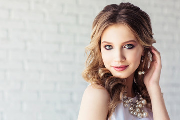 Beautiful young girl in a white dress. Fashion portrait