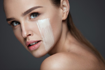 Wall Mural - Attractive Young Woman With Stripe Of Foundation On Face