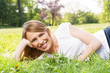 © Goran - Happy woman lying in grass