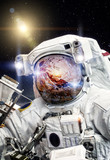 Fototapeta Kosmos - Astronaut in open space (Elements of this image furnished by NASA)