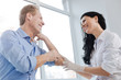 © zinkevych - Joyful dermatologist enjoying conversation with patient in the hospital